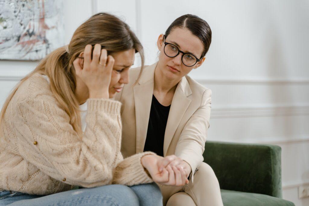female counsellor comforting overwhelmed female